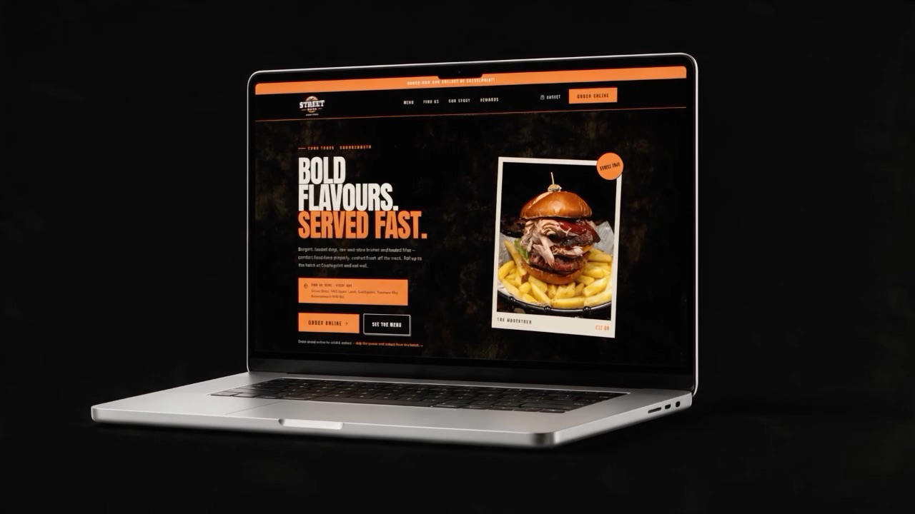 The Street Bites desktop homepage on a laptop, turned three-quarters to camera, showing the headline Bold Flavours. Served Fast.