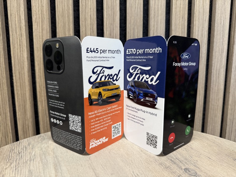 Ford Foray Motor Group phone-shaped die-cut direct mail pieces standing on a table